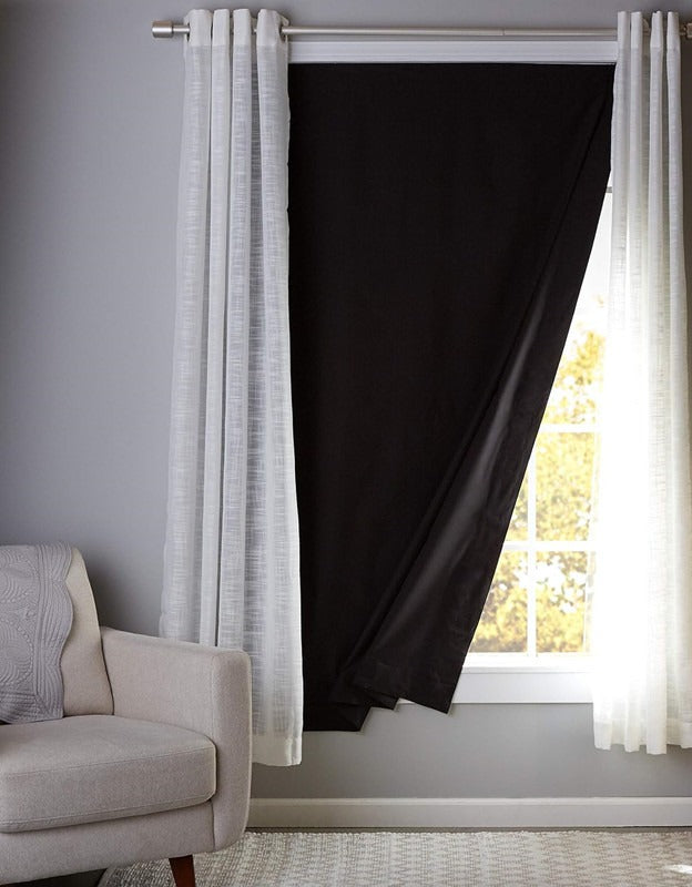AVXT Portable Blackout Blind stuck to a bedroom window, blocking the daylight