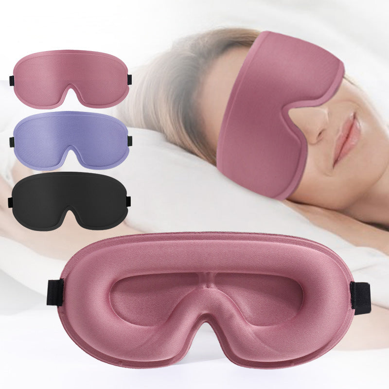 The AVXT Blackout Eye Mask in pink, purple and black, and a person asleep in the pink one